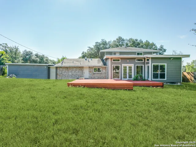 a view of house with a yard