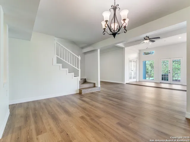 a view of a livingroom with wooden floor and a ceiling fan