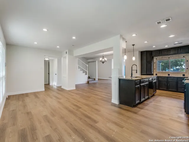 a view of kitchen with kitchen island sink and center island
