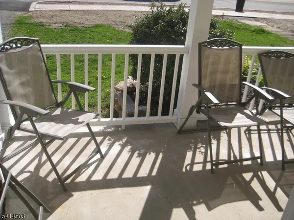 a view of balcony with wooden floor and outdoor seating