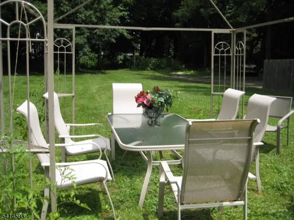 a view of yard with furniture and garden