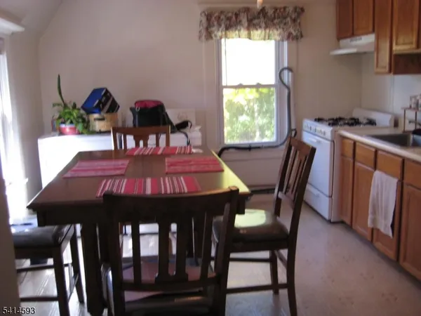 a view of a dining room with furniture and window