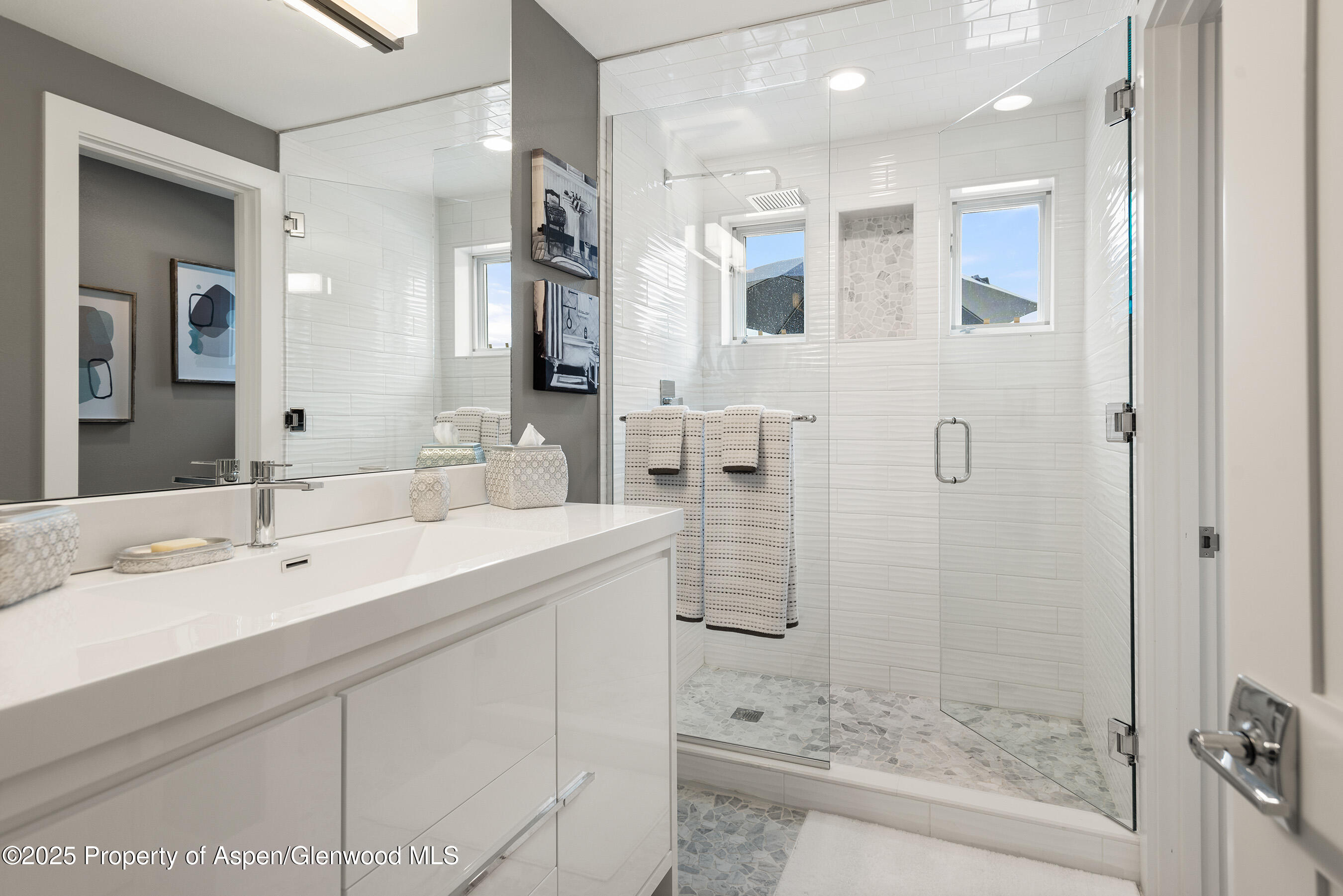 1167 Juniper Hill Road Aspen, CO 81611 - Photo 27 of 60 a bathroom with a shower sink and mirror