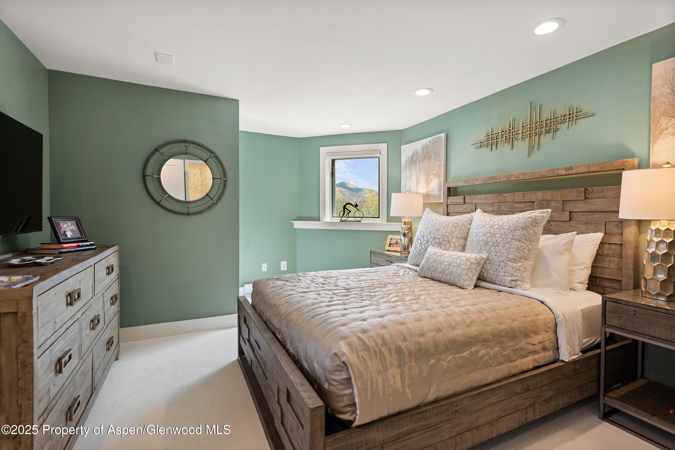 1167 Juniper Hill Road Aspen, CO 81611 - Photo 29 of 60 a bedroom with a bed and a mirror