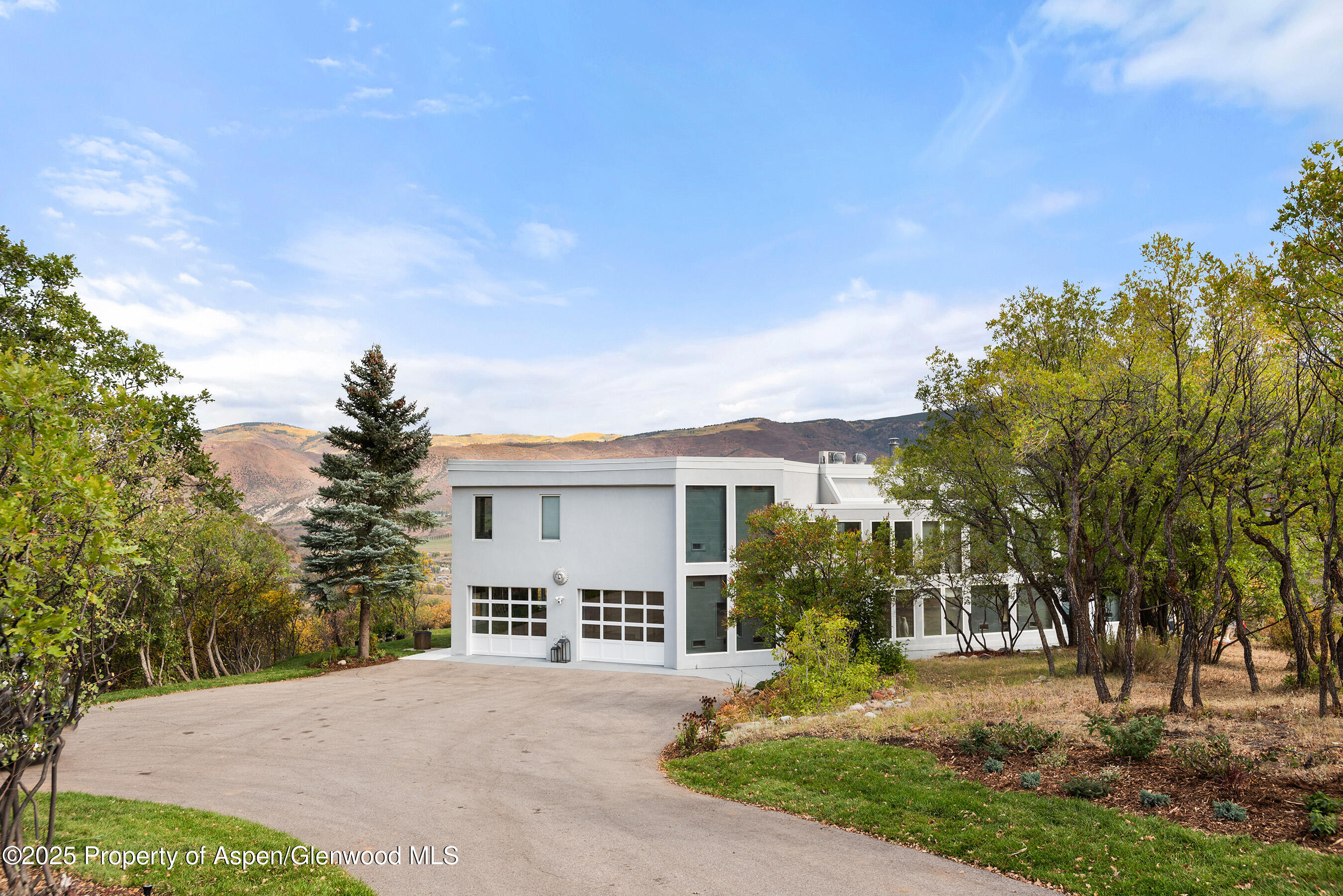 1167 Juniper Hill Road Aspen, CO 81611 - Photo 39 of 60 a view of house in front of a big yard with large trees
