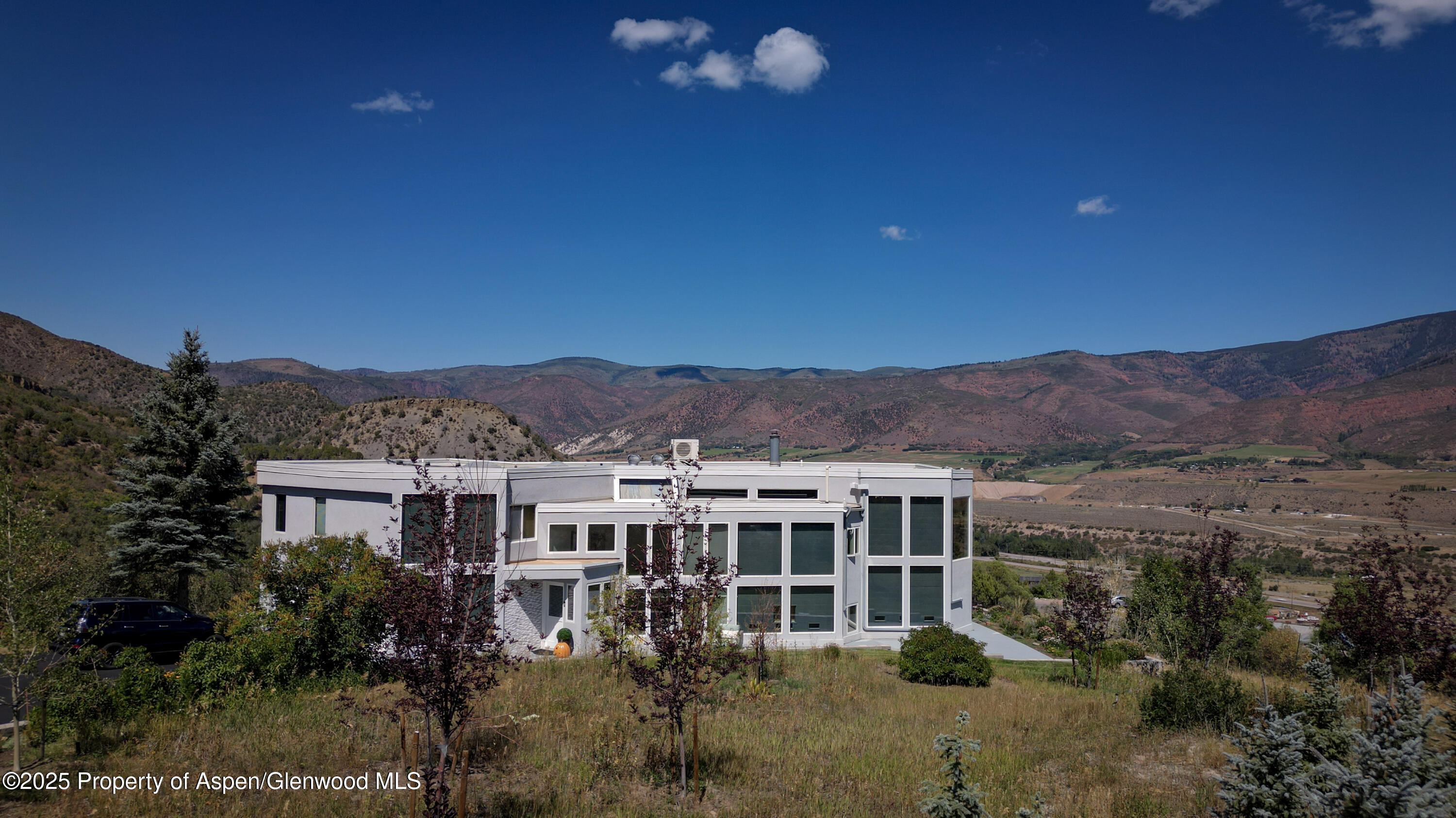 1167 Juniper Hill Road Aspen, CO 81611 - Photo 53 of 60 a view of a big house with a big yard and mountain view