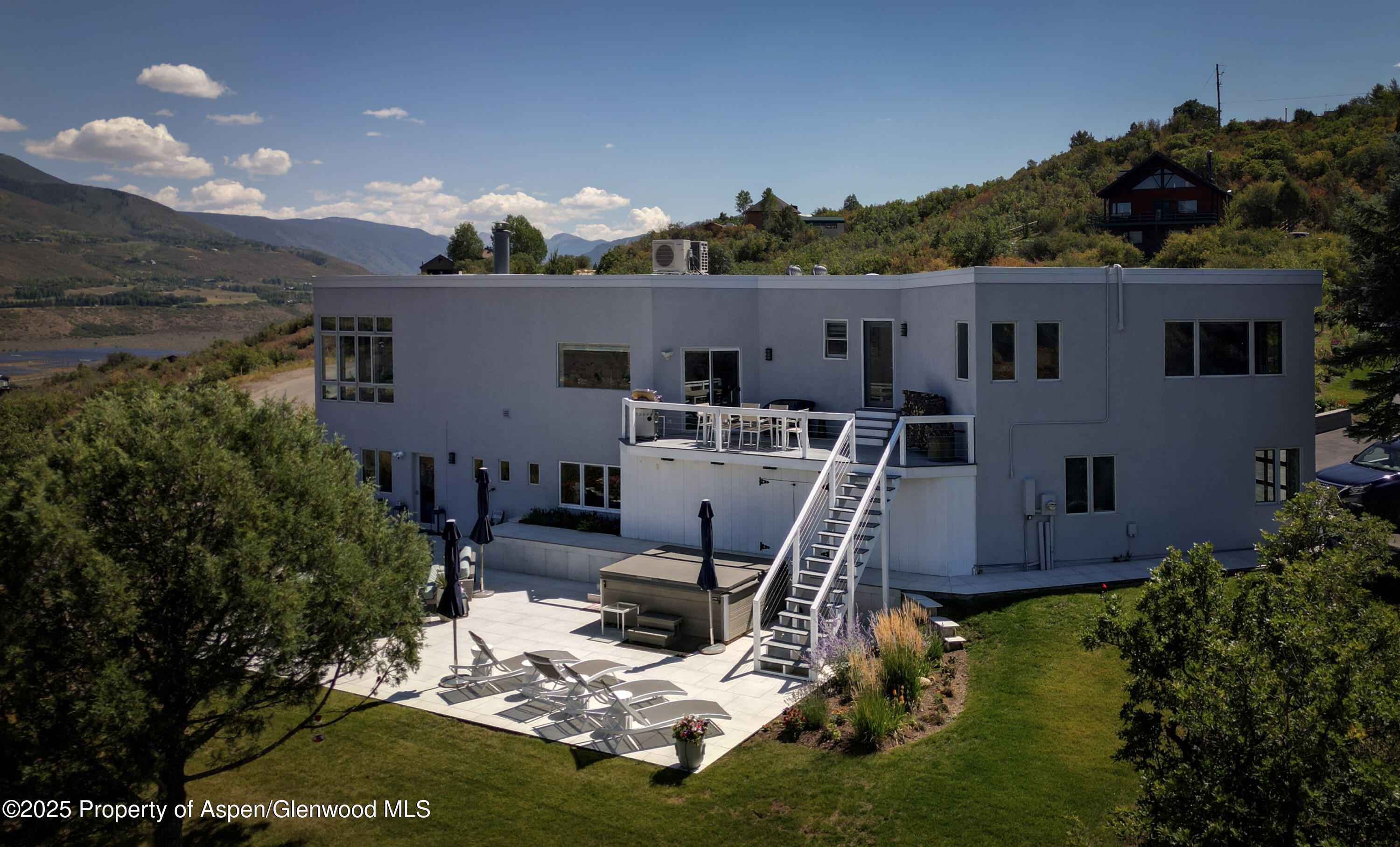1167 Juniper Hill Road Aspen, CO 81611 - Photo 56 of 60 a view of a backyard with plants potted plants and large tree