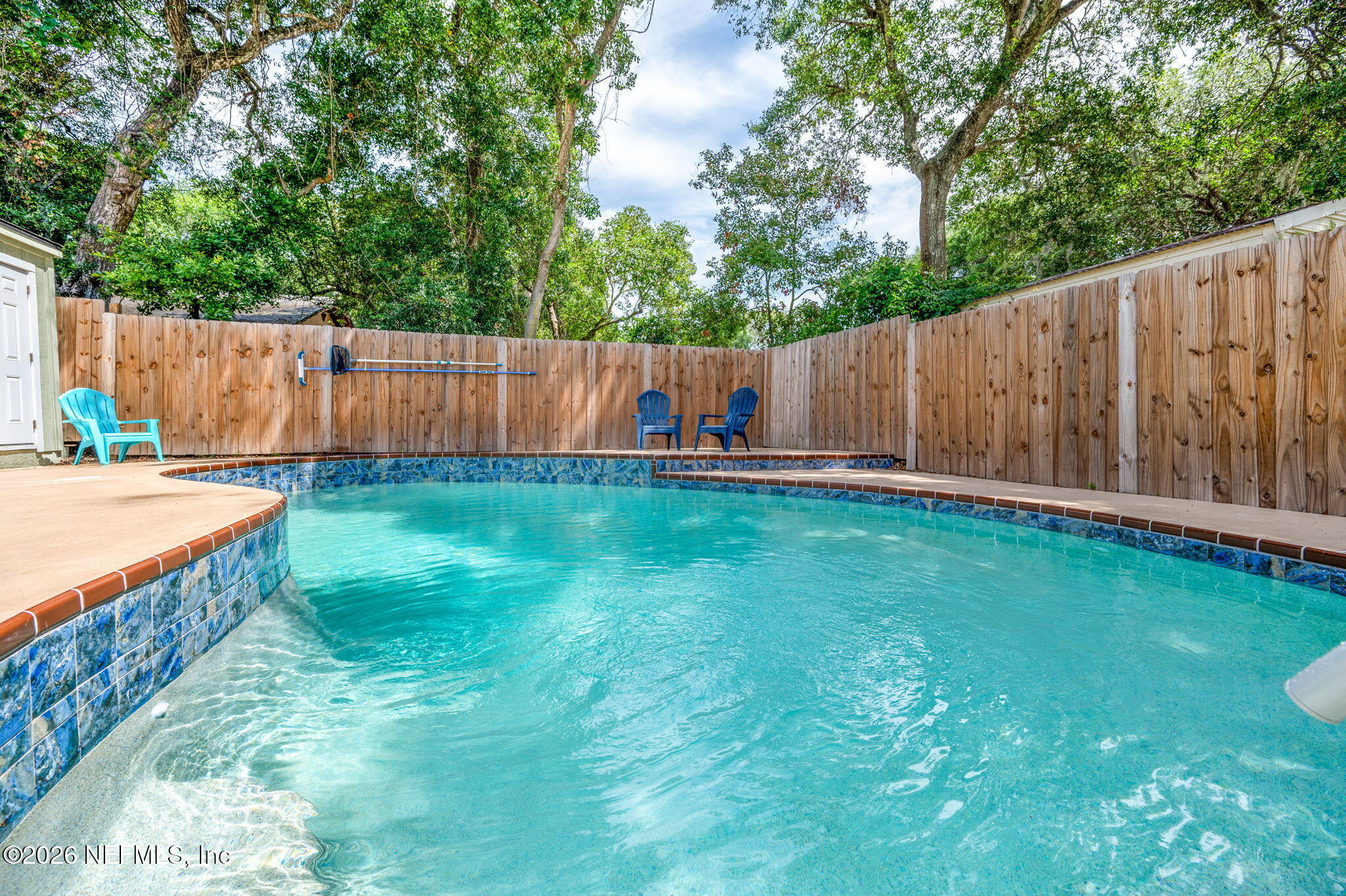 507 Gentian Road St. Augustine, FL 32086 - Photo 18 of 82 a view of a backyard with wooden fence and a bench