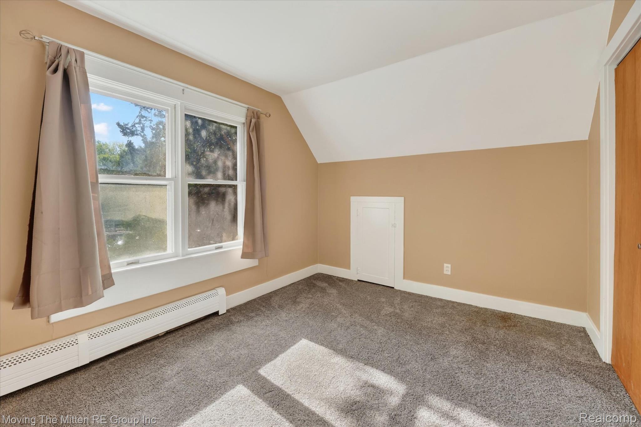 25505 Wick Road Taylor, MI 48180 - Photo 25 of 68 Additional living space featuring a baseboard heating unit, vaulted ceiling, and carpet flooring