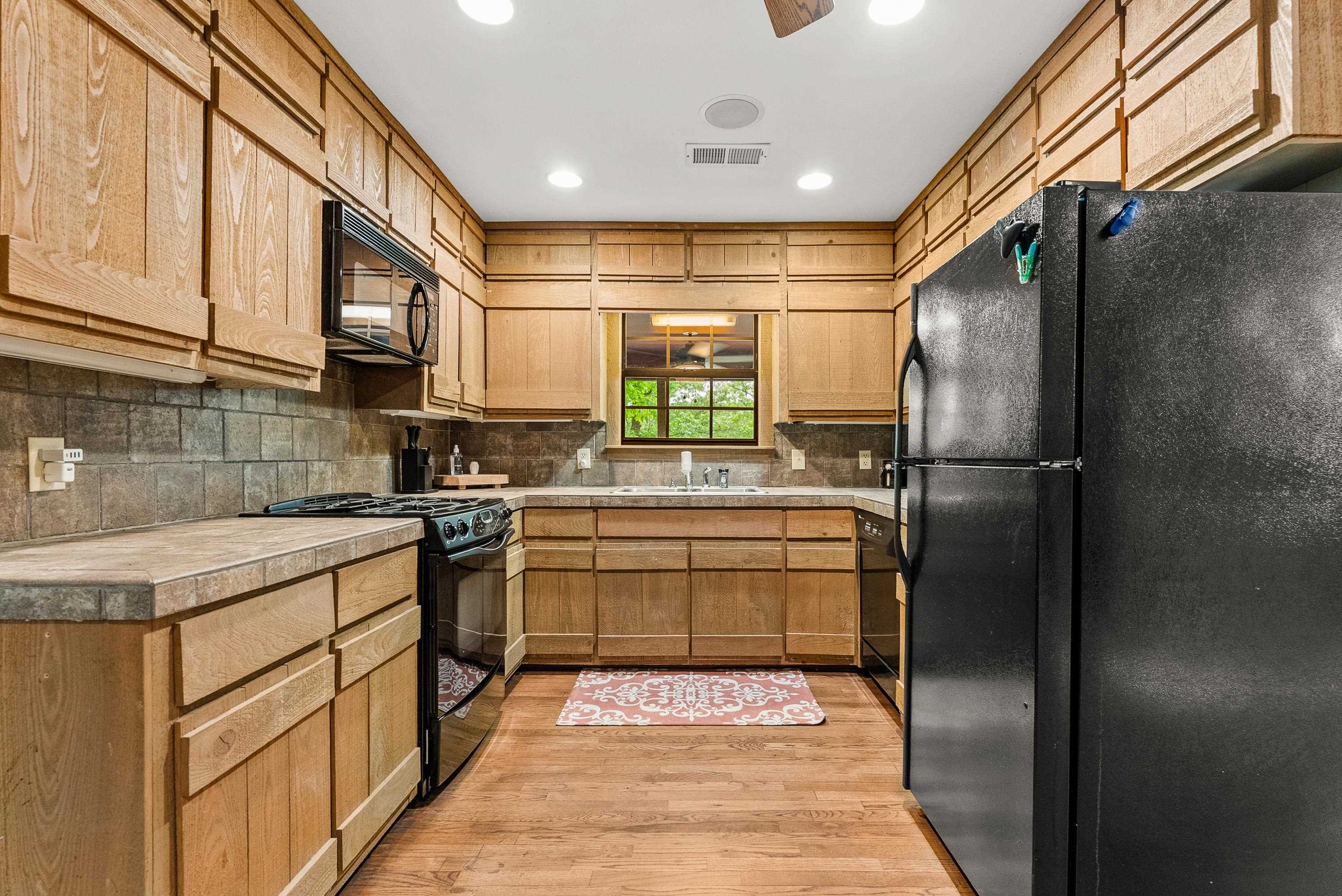 2275 Cypress Road Pocahontas, TN 38061 - Photo 19 of 34 Kitchen featuring black appliances, light wood-style floors, decorative backsplash, recessed lighting, and a sink