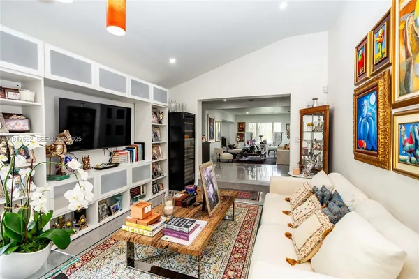 a living room with lots of furniture and a flat screen tv