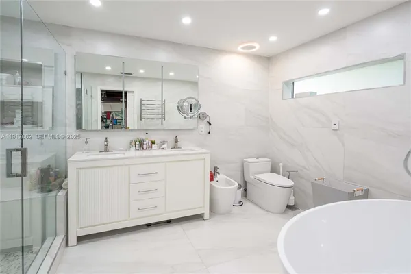 a spacious bathroom with a double vanity sink mirror and toilet