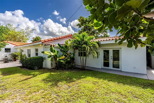 a front view of a house with a garden