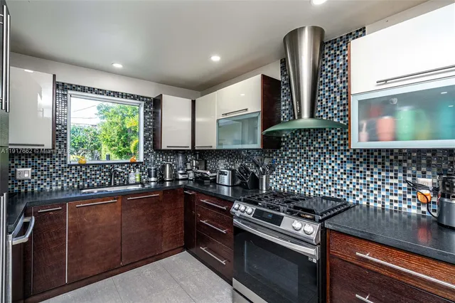 a kitchen with a sink a stove and wooden cabinets