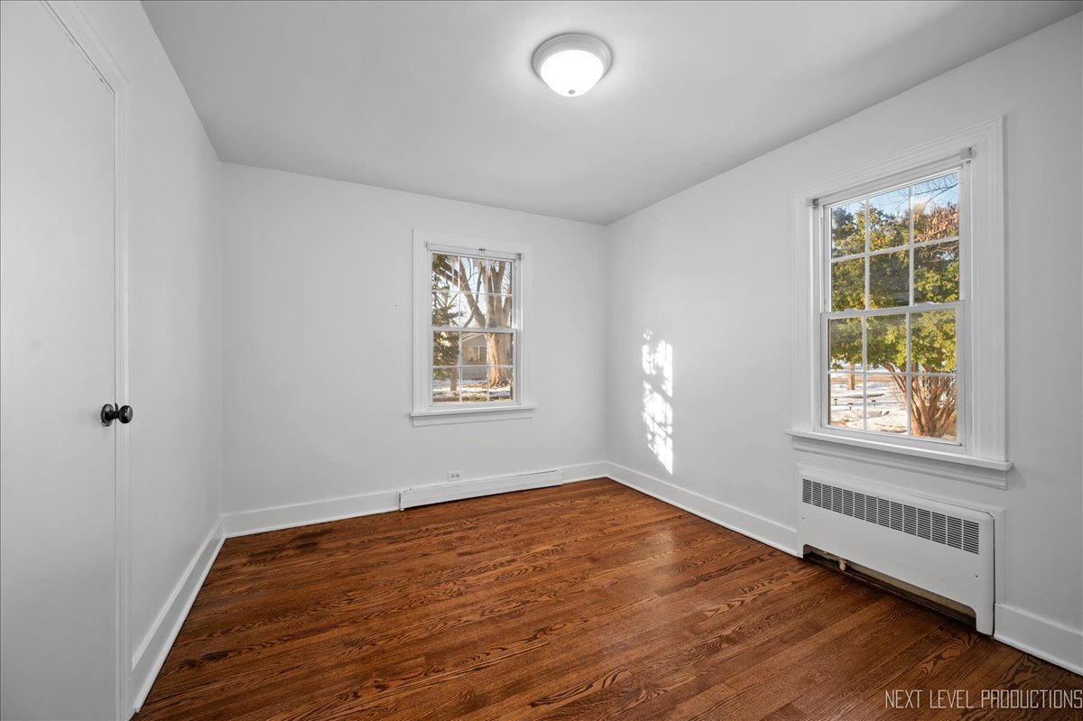 1326 South Elm Street St. Charles, IL 60174 - Photo 16 of 27 an empty room with wooden floor and windows