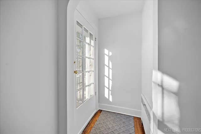 a view of front door with furniture and a window