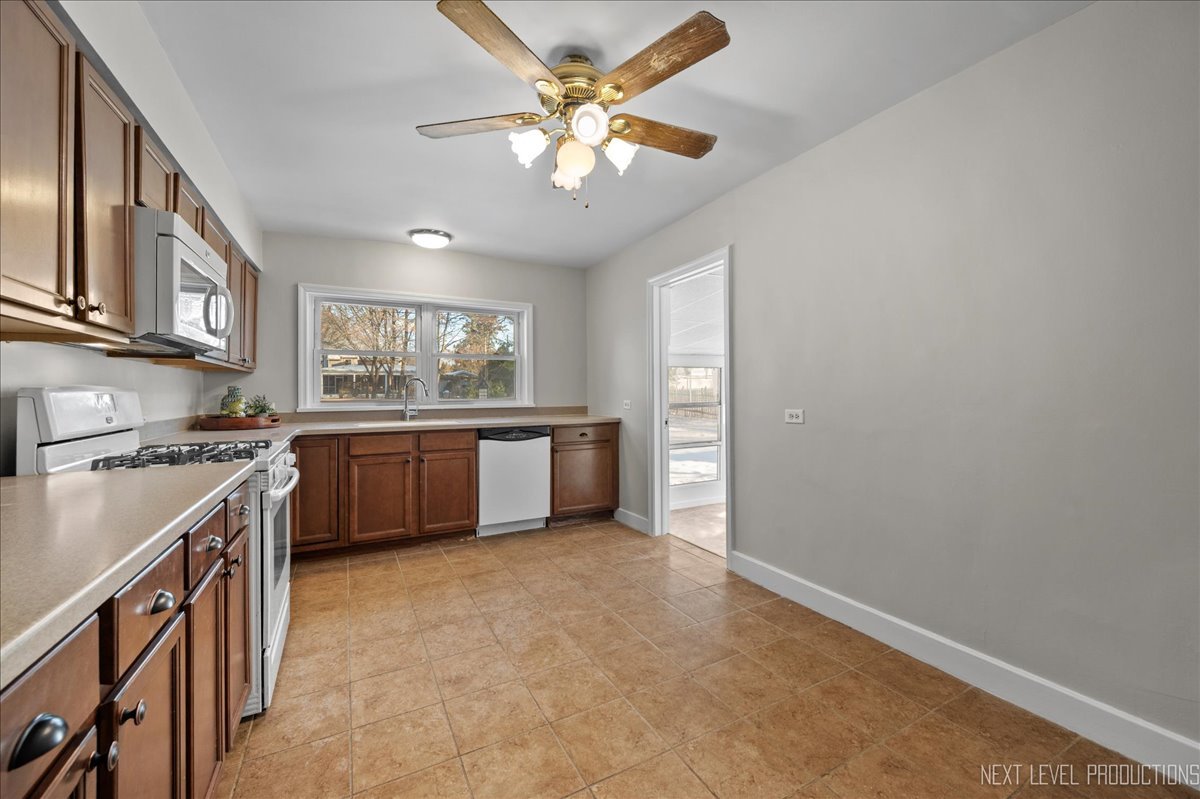 1326 South Elm Street St. Charles, IL 60174 - Photo 8 of 27 a kitchen with stainless steel appliances a sink stove and cabinets