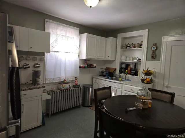 a kitchen with kitchen island granite countertop a sink stainless steel appliances and cabinets