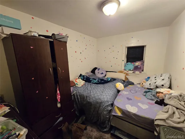 a bedroom with furniture and a flat screen tv