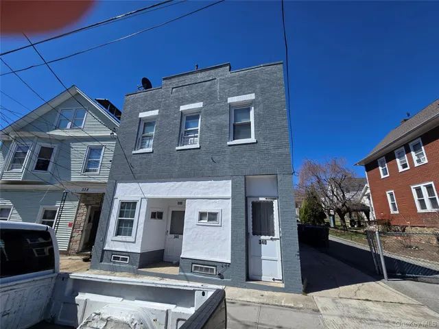a front view of a house with plants