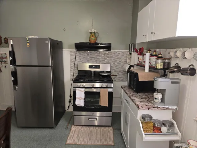 a kitchen with a refrigerator and a stove