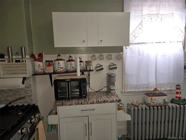 a kitchen with a stove and cabinets