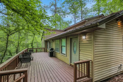 a view of backyard with deck and outdoor seating