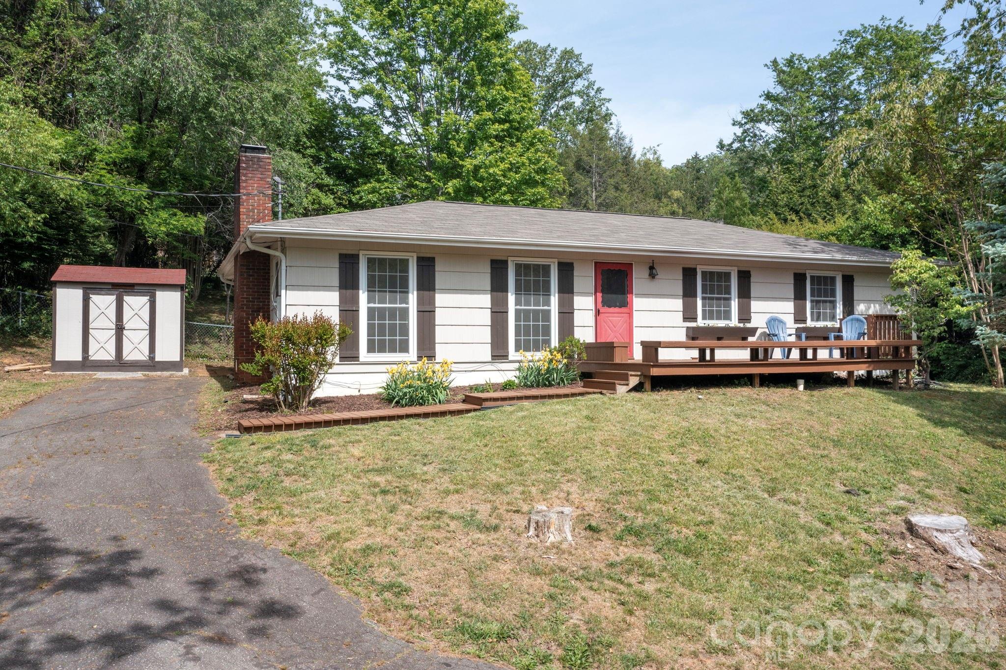 34 Wolfe Cove Road Asheville, NC 28804 - Photo 2 of 42 a view of a house with backyard sitting area and swimming pool