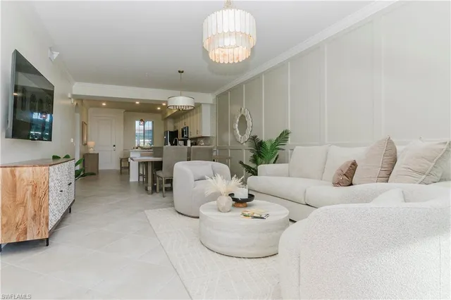 a living room with furniture and a chandelier