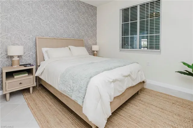 a bedroom with a bed and a night stand