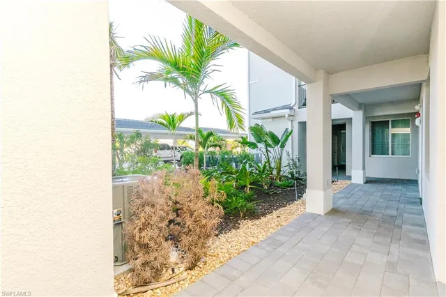 a view of a hallway with wooden shelves