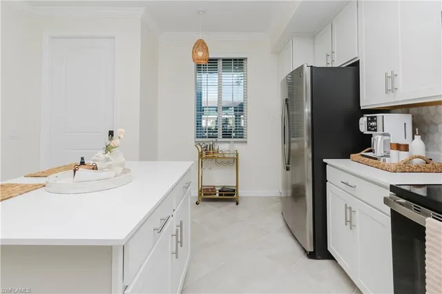 a kitchen with a refrigerator and a sink