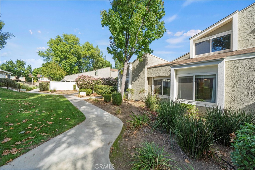 24243 Lema Drive Valencia, CA 91355 - Photo 29 of 37 a front view of a house with a yard and shrubs