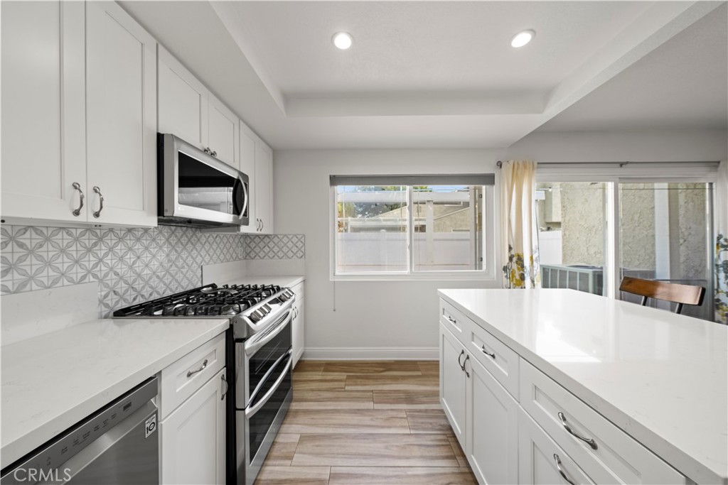 24243 Lema Drive Valencia, CA 91355 - Photo 3 of 37 a kitchen with a sink stove top oven and refrigerator