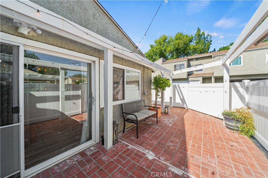 24243 Lema Drive Valencia, CA 91355 - Photo 31 of 37 a view of a patio with table and chairs and potted plants