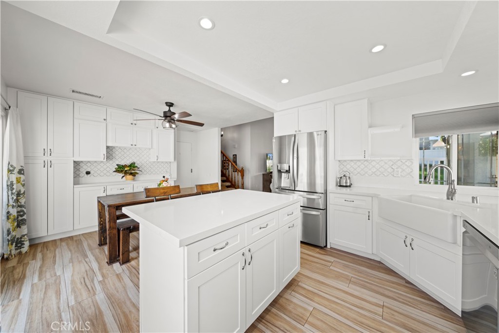 24243 Lema Drive Valencia, CA 91355 - Photo 5 of 37 a kitchen with white cabinets and stainless steel appliances