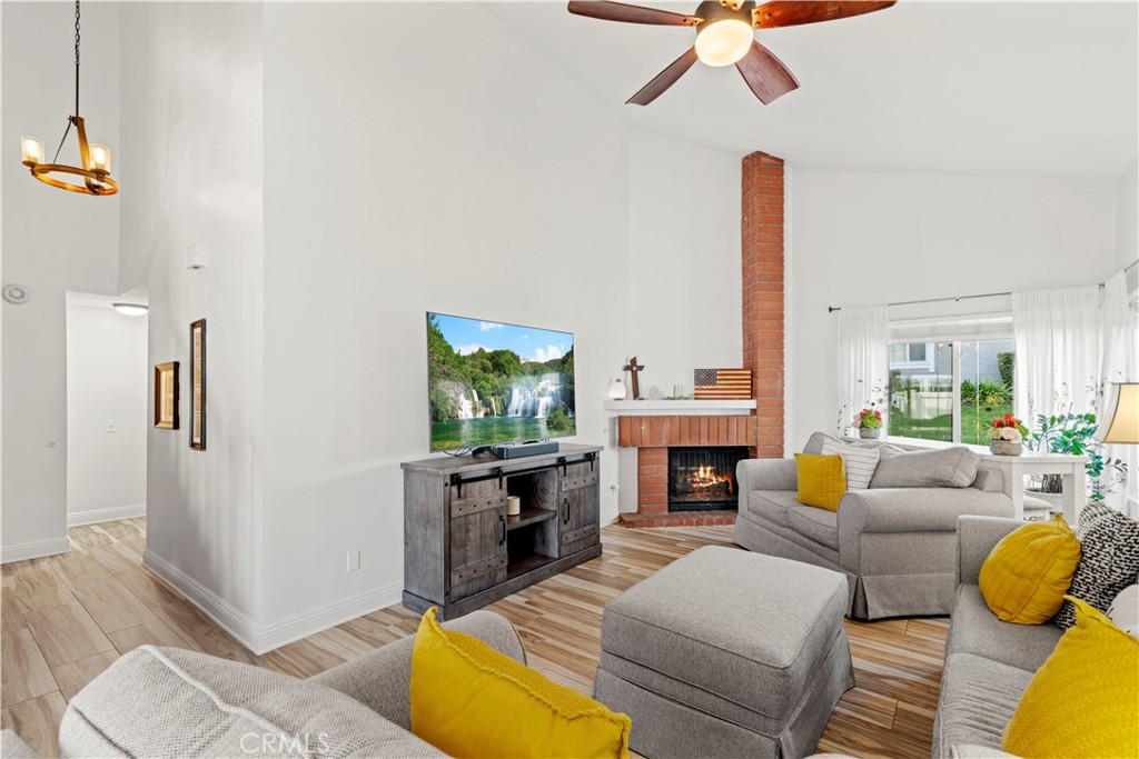24243 Lema Drive Valencia, CA 91355 - Photo 9 of 37 a living room with furniture a fireplace and a chandelier