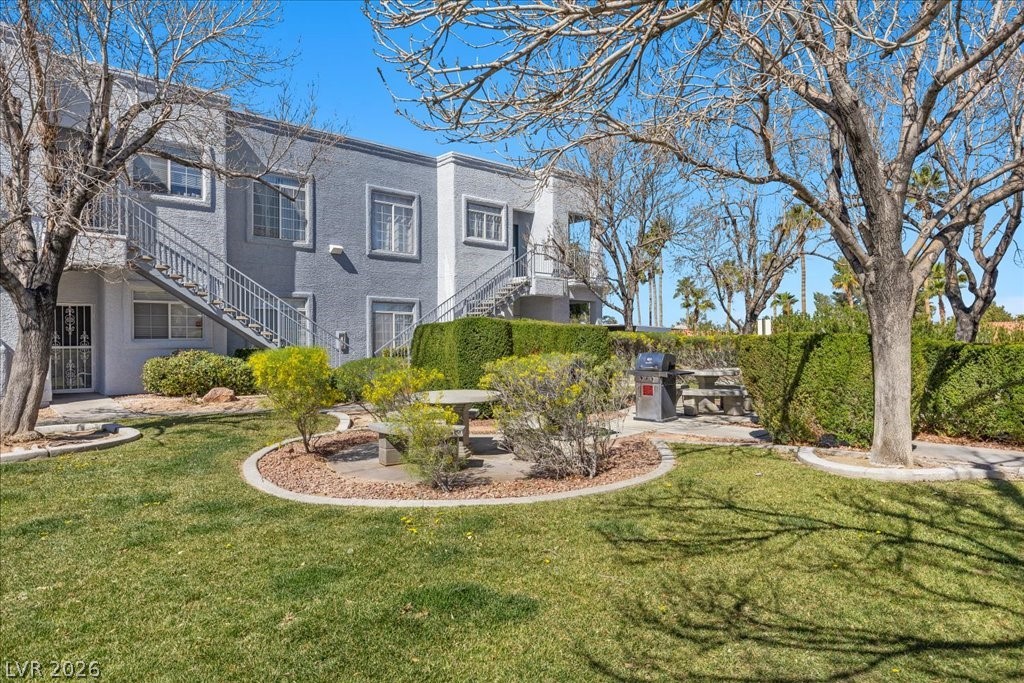 2201 Ramsgate Drive, Unit 818 Henderson, NV 89074 - Photo 22 of 31 View of green lawn with stairs and a patio