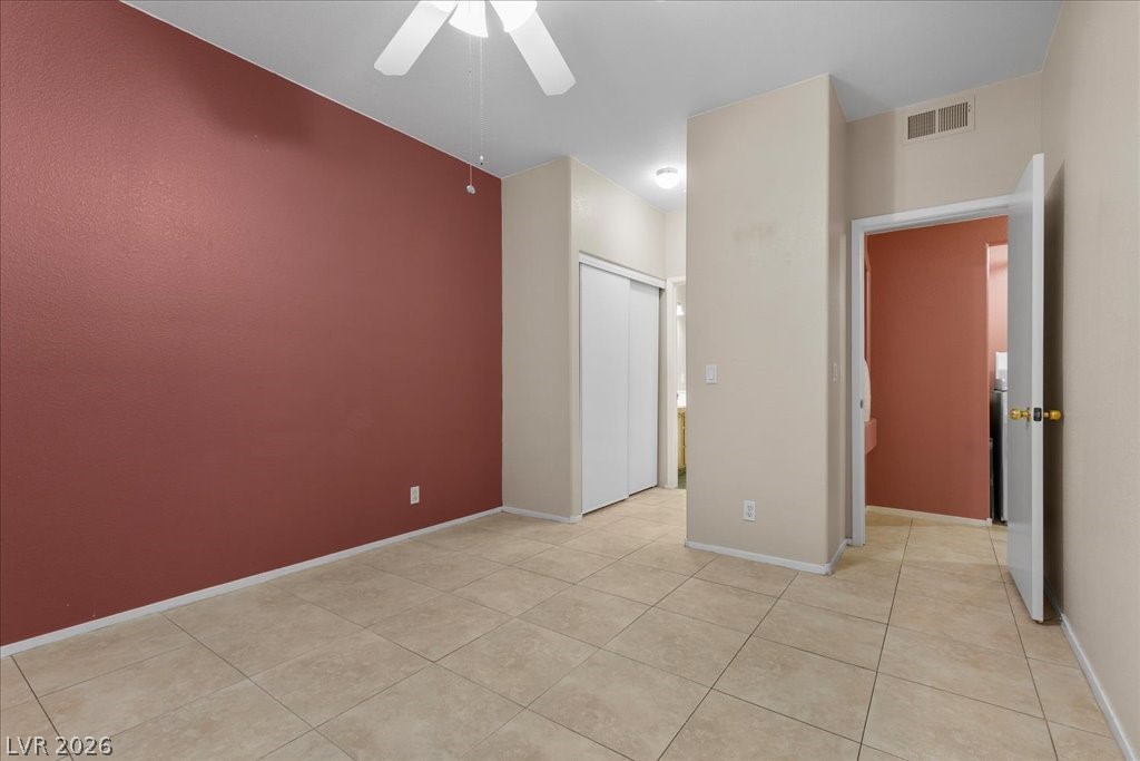 2201 Ramsgate Drive, Unit 818 Henderson, NV 89074 - Photo 10 of 31 Empty room with a ceiling fan and light tile patterned floors