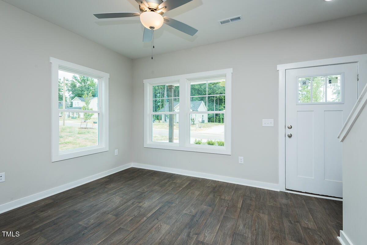 1016 Pinnix Loop Burlington, NC 27217 - Photo 7 of 22 a view of an empty room with wooden floor and a window