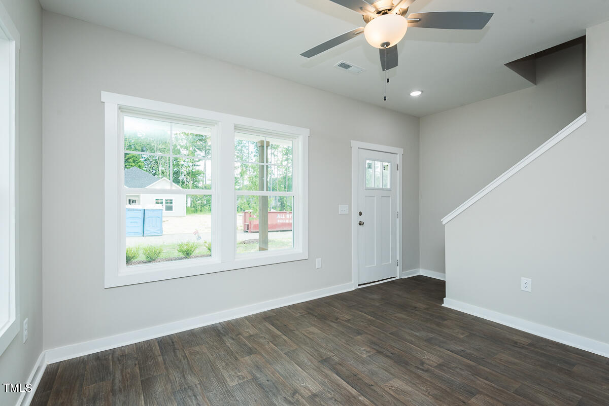 1016 Pinnix Loop Burlington, NC 27217 - Photo 8 of 22 a view of an empty room with wooden floor and a window
