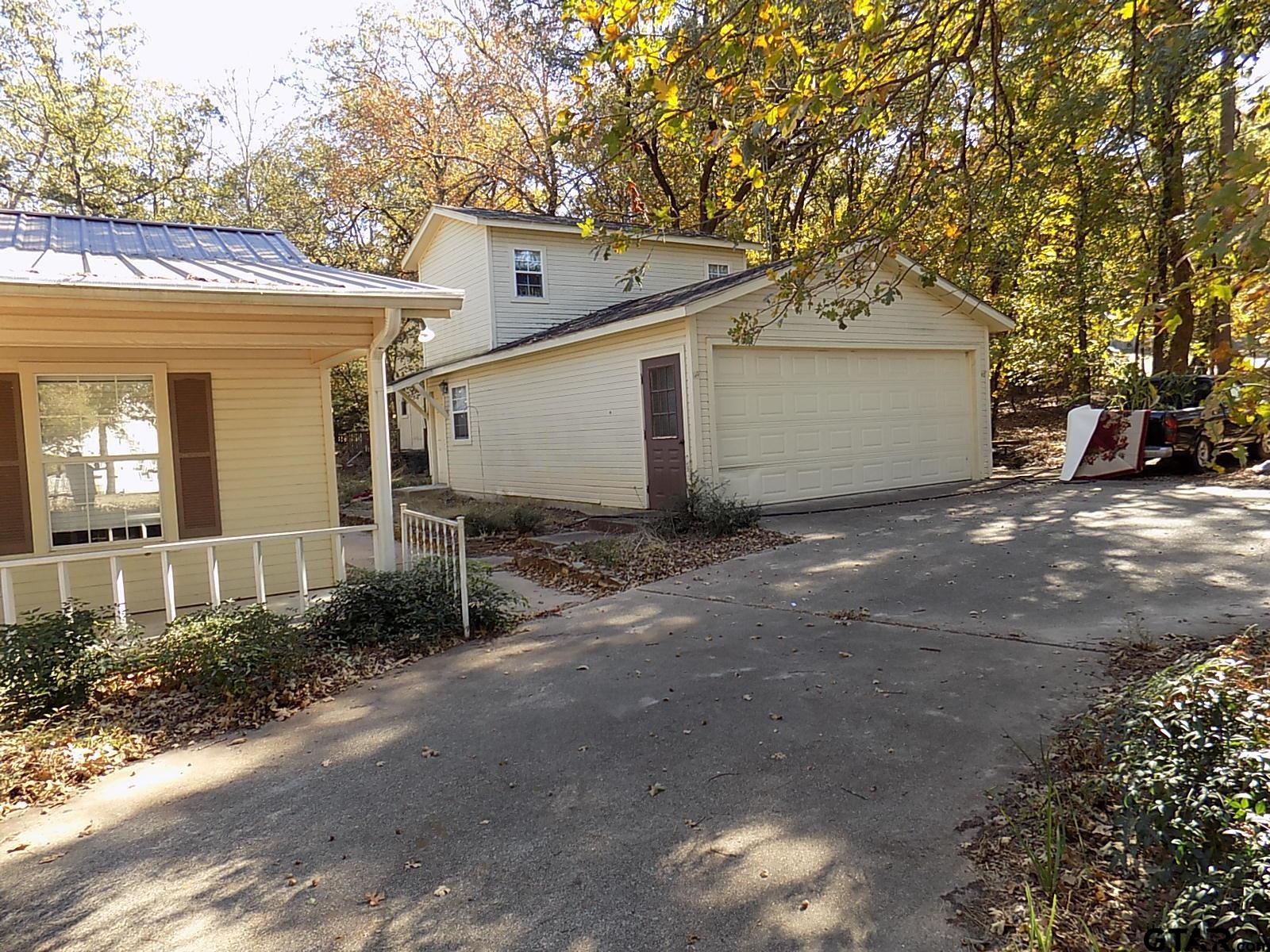 111 Laurel Lane Holly Lake Ranch, TX 75765 - Photo 17 of 43 a view of a house with a yard and garage