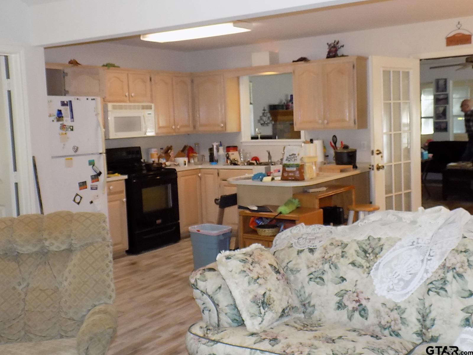 111 Laurel Lane Holly Lake Ranch, TX 75765 - Photo 22 of 43 a bed room with a bed and a kitchen