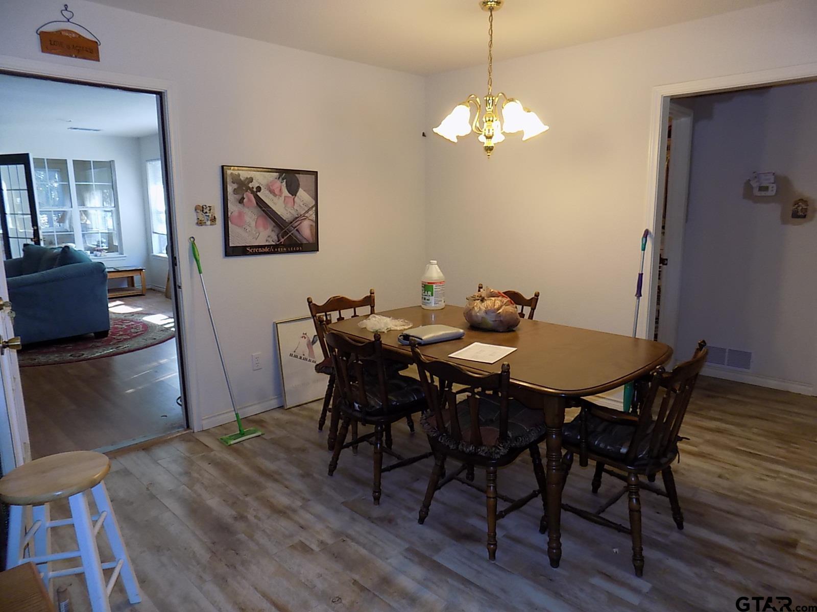 111 Laurel Lane Holly Lake Ranch, TX 75765 - Photo 24 of 43 a view of a dining room with furniture and wooden floor