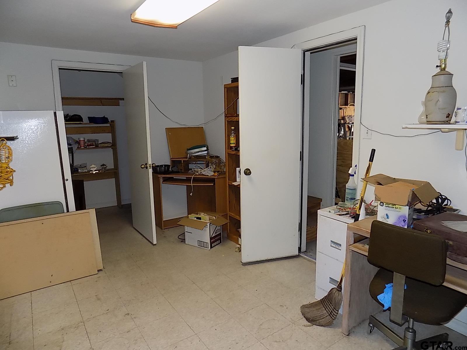 111 Laurel Lane Holly Lake Ranch, TX 75765 - Photo 40 of 43 a view of a workspace with furniture and a bedroom