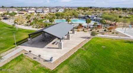 a view of a swimming pool with outdoor seating and a lake view