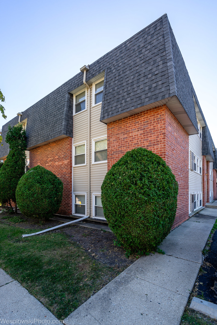 1288 Perry Street, Unit P1 Des Plaines, IL 60016 - Photo 12 of 13 a front view of a house with a garden