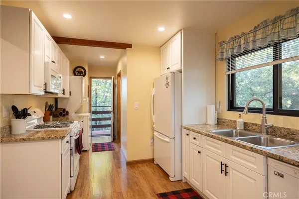 a kitchen with sink refrigerator and window