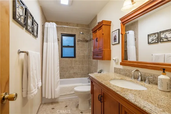 a bathroom with a sink a toilet and bathtub