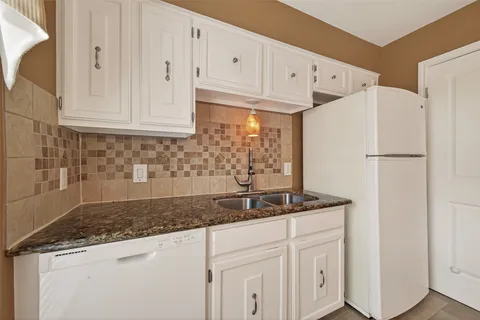 a kitchen with a stove and a refrigerator